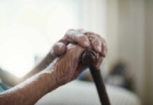 Stem Cell Miracle: Reversing Aging In Elders Close-up of elderly hands resting on a cane