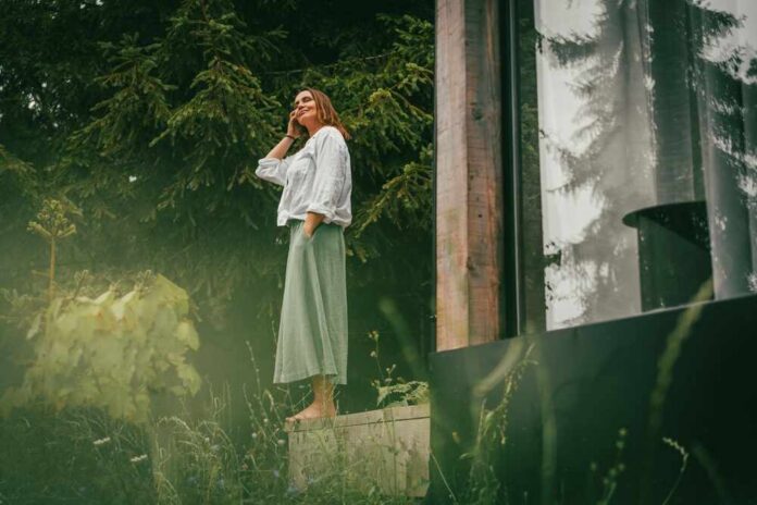 Adult,Mature,Caucasian,Woman,Enjoying,Morning,On,Forest,Cottage,Terrace