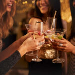 Gen Z’s Alcohol Rejection: A Game Changer Group of friends toasting with cocktails at a party