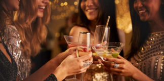 Group of friends toasting with cocktails at a party