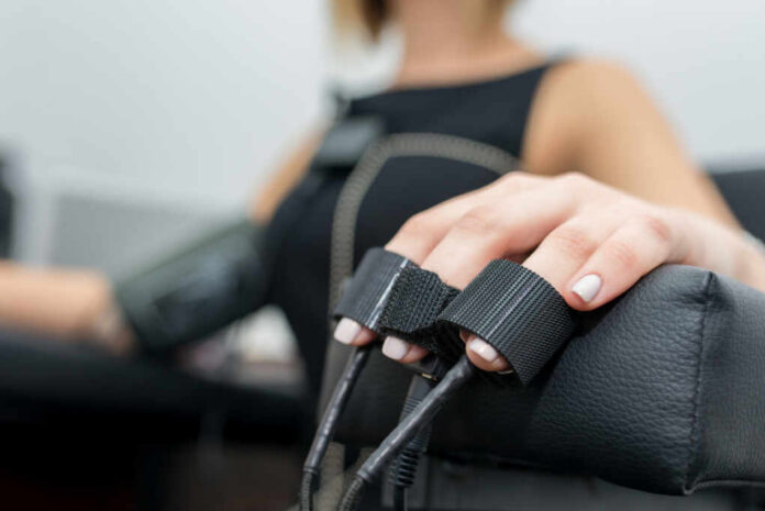 shutterstock_1118685239.jpg Close-up of a patients hand during a medical examination with monitoring equipment