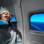 Sleep Apnea—New Pill Changes Everything A passenger sleeping on an airplane with headphones and an eye mask