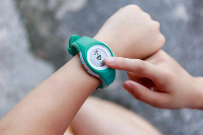 shutterstock_1789899068.jpg Person using a fitness tracker on their wrist