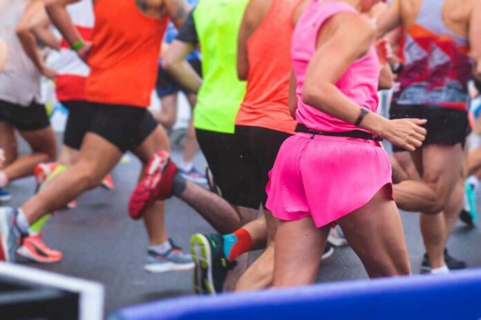 shutterstock_2272302195.jpg Runners participating in a marathon, wearing colorful athletic gear