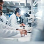 Hidden Molecule May Stop Alzheimer’s Cold Scientists working in a laboratory with microscopes and test tubes