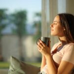 Could Your Coffee Habit Save Your Brain? Woman enjoying a cup of coffee in a sunlit room