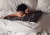 Silent Sleep Thief Ages Your Brain Child lying in bed with hands over ears