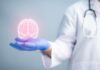 Dementia Threat: Are You Missing This Simple Fix? A medical professional holding a glowing digital brain illustration in their hand