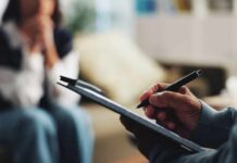 Stress-Busting Habits Experts Swear By A therapist taking notes during a session with a client in the background