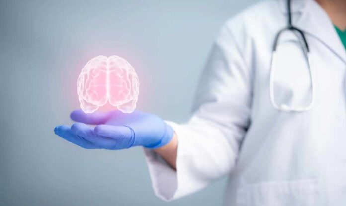 A,Medical,Worker,Hand,Holding,Brain,Analysis,And,Medicine.,Mental A medical professional holding a glowing digital brain illustration in their hand