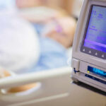 Leg-lengthening Surgeries And Its Serious Risks IV pump displaying medication flow rate in a hospital room