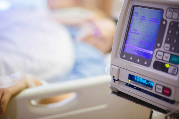 shutterstock1449440597jpg-2 IV pump displaying medication flow rate in a hospital room