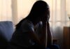 When Self-Help Becomes Self-Harm A silhouette of a person sitting with their head in their hands, conveying distress