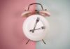Intermittent Fasting Over 60: Hidden Dangers? An alarm clock with a plate and two forks arranged in a creative design