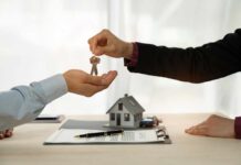 A person handing over house keys during a real estate transaction