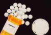 Silent Shield Against Fentanyl Emerges Prescription bottle of fentanyl with white pills scattered around