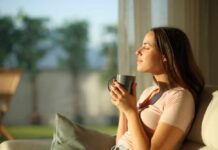 Green Tea’s Effect on Brain Decay Woman enjoying a cup of coffee in a sunlit room