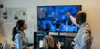 Security team monitors multiple surveillance screens in control room