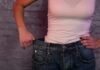 Hidden Risks of Low Muscle Mass person in white tank top showing loose jeans waistband