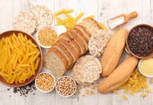 Silent Carb Trap Wrecking Metabolism Assorted grains and breads on a wooden table