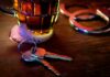 House keys on bar beside beer mug and handcuffs
