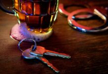 Why Quitting alcohol may prime the brain for relapse House keys on bar beside beer mug and handcuffs