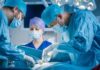 Surgeons perform an operation in a hospital operating room