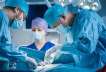 Leg-Lengthening Surgery and Its Serious Complications Surgeons perform an operation in a hospital operating room