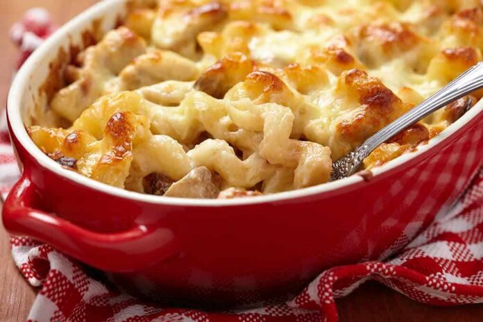 shutterstock_174655184 Baked pasta casserole with golden melted cheese in a red dish