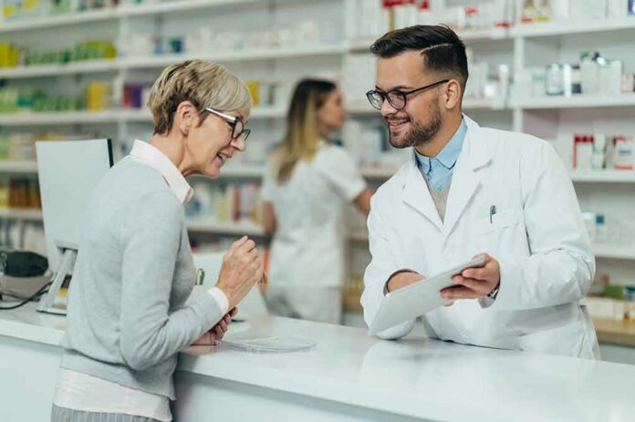 Pharmacist assists customer at pharmacy counter