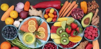 Assorted fruits, vegetables, and salmon slices on plates