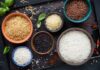Easy cooking methods that flush arsenic out of rice Assorted rice varieties in bowls on a dark tray
