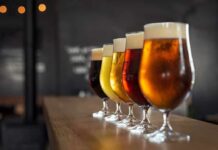 Row of craft beers in tulip glasses on a bar