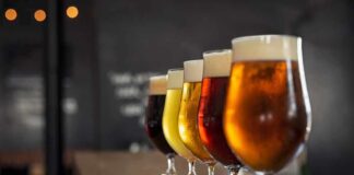 Row of craft beers in tulip glasses on a bar