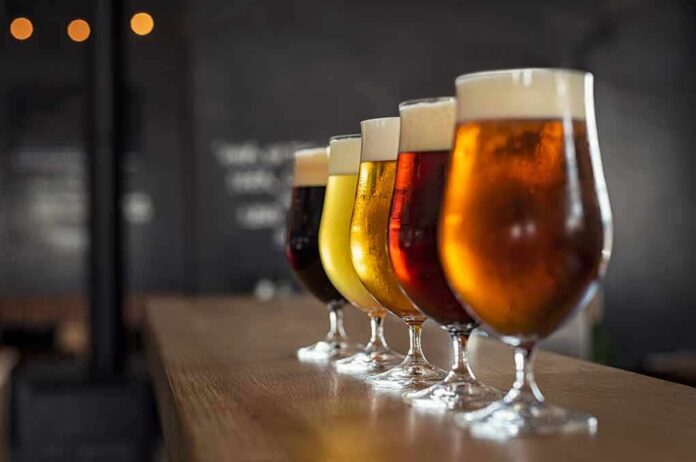 Row of craft beers in tulip glasses on a bar