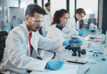 Scientist using a microscope in a modern laboratory