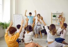 Five-Minute Hack Supercharges Parent–Kid Bond Children raise hands in a classroom circle with teacher clapping
