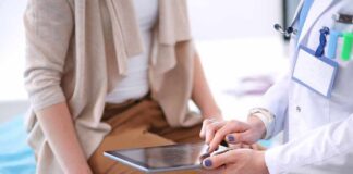 doctor showing patient information on a tablet