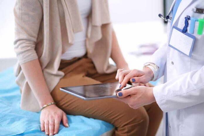 doctor showing patient information on a tablet