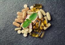 Harvard Warning: High Vitamin D Dangers Mixed dietary supplements on dark stone surface