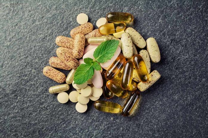 Mixed dietary supplements on dark stone surface