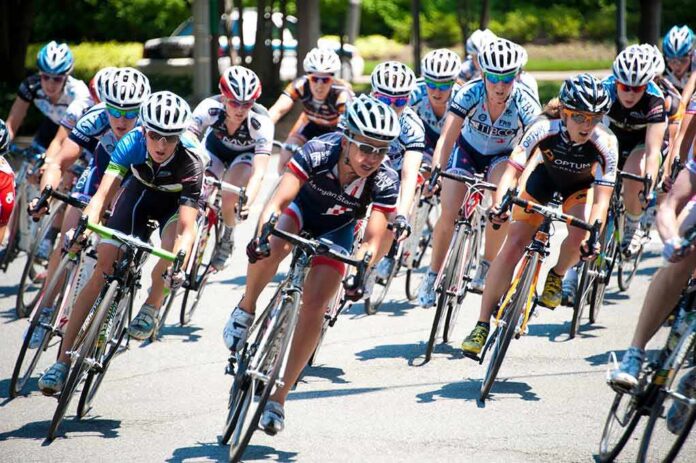 shutterstock_104846546 Valérie Maltais, Amy Pieters, Gianni Meersman, and Michael Špaček racing in a cycling peloton