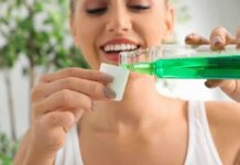 Woman pouring green mouthwash into a cap