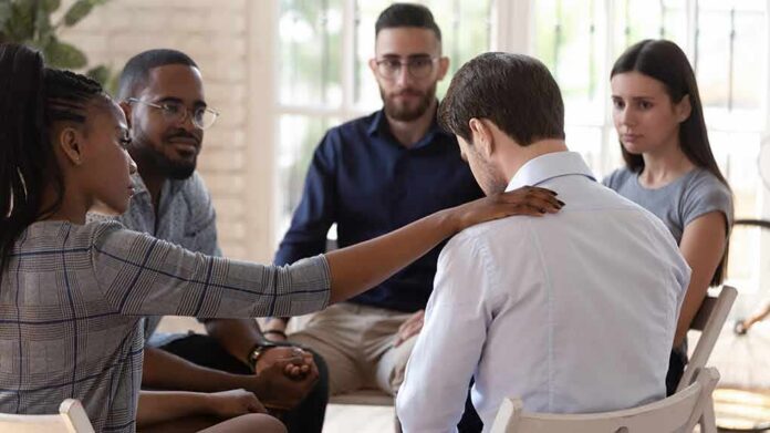 support group comforting a man