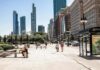 City Design Quietly Steals Your Health City street with pedestrians and tall modern skyscrapers
