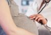 Hidden Antibodies Linked To Early Births Pregnant woman examined with stethoscope