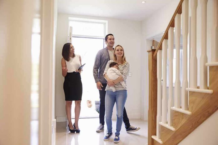 shutterstock_451242226 Nick Nanton and a couple with a baby tour a bright home entryway